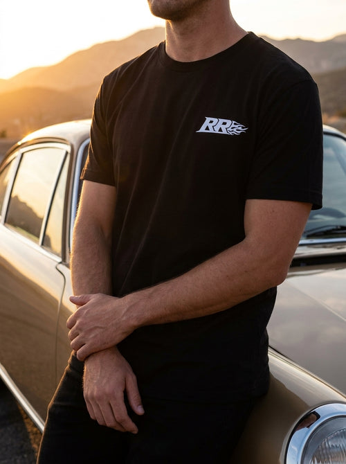 Rowdy Ridez Heavyweight Tee worn at sunset next to a classic car